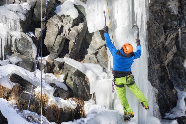 man climbing ice in mountain